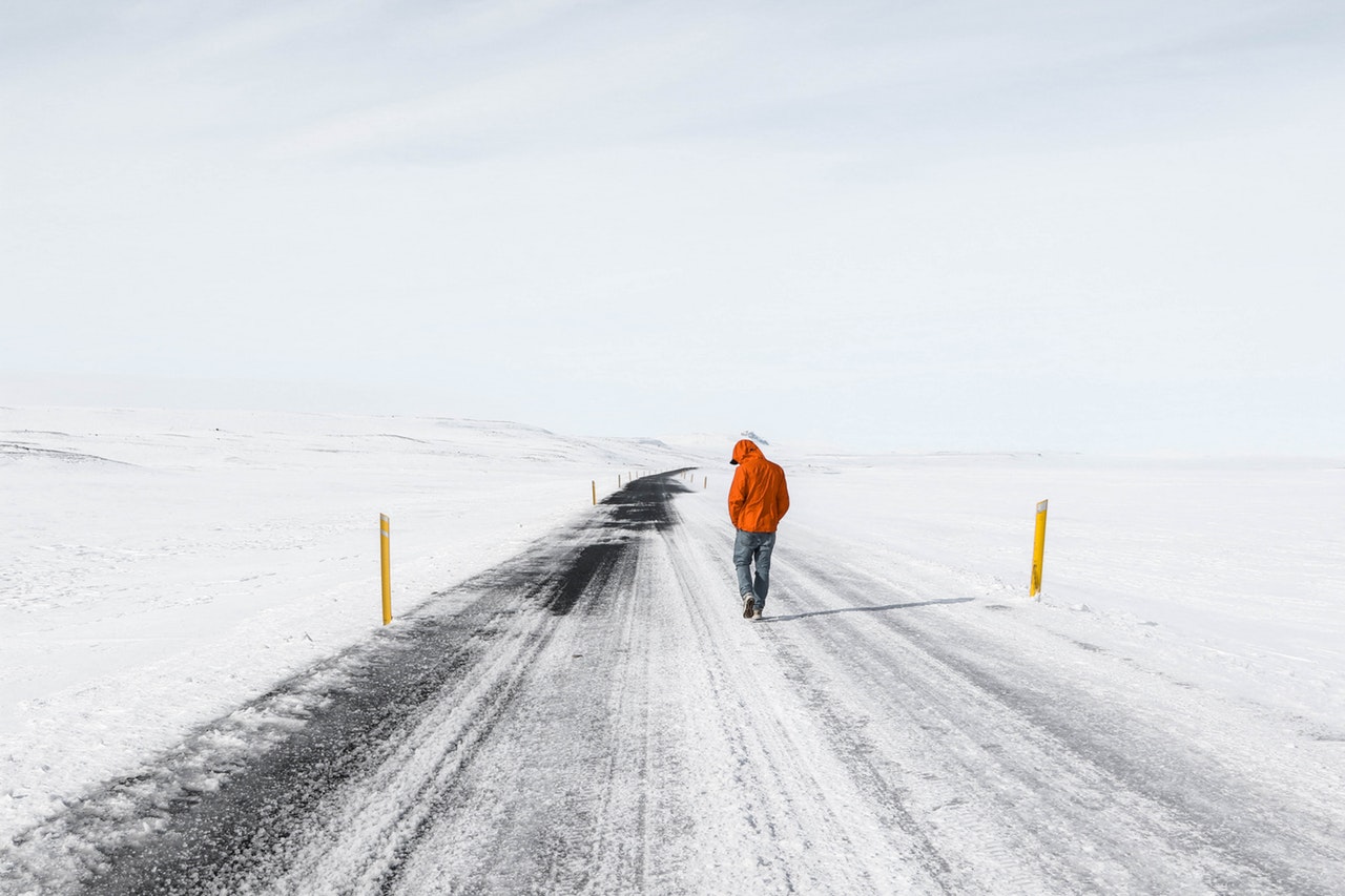 person walking at road covered in snow