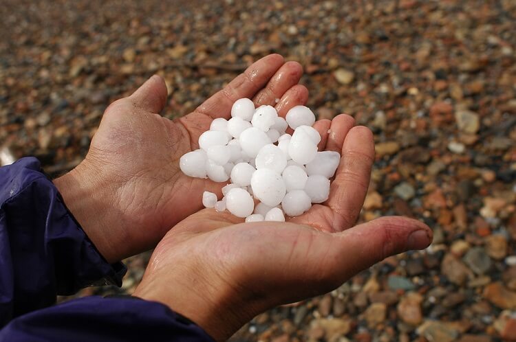 man holding hail in his hands