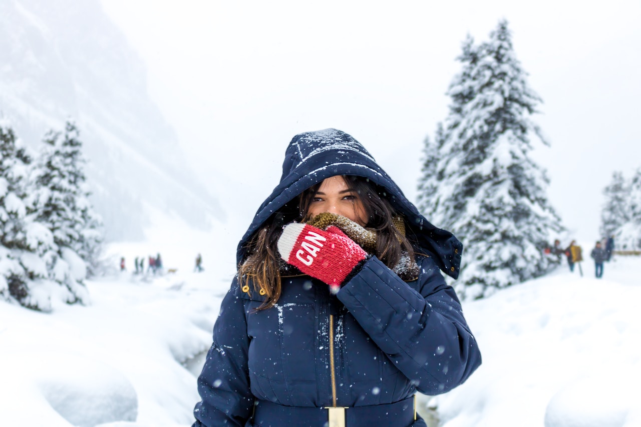 woman wearing jacket and gloves