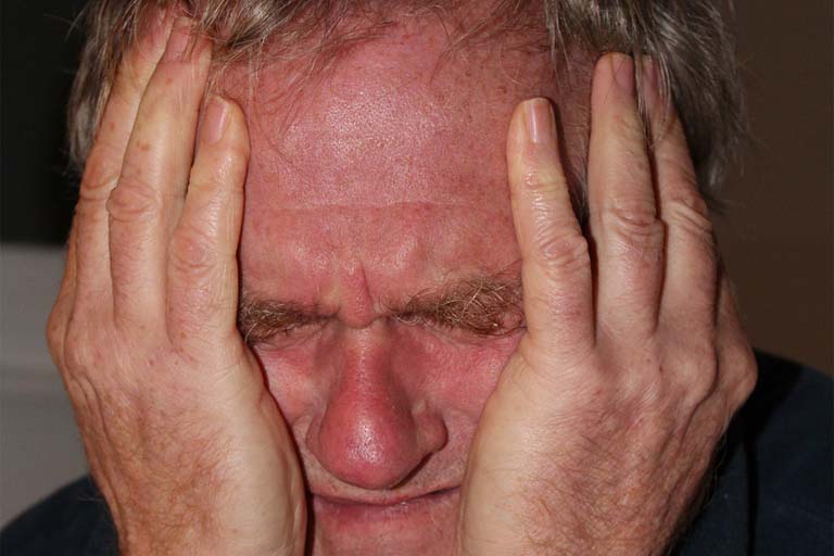grimace face of a man in pain