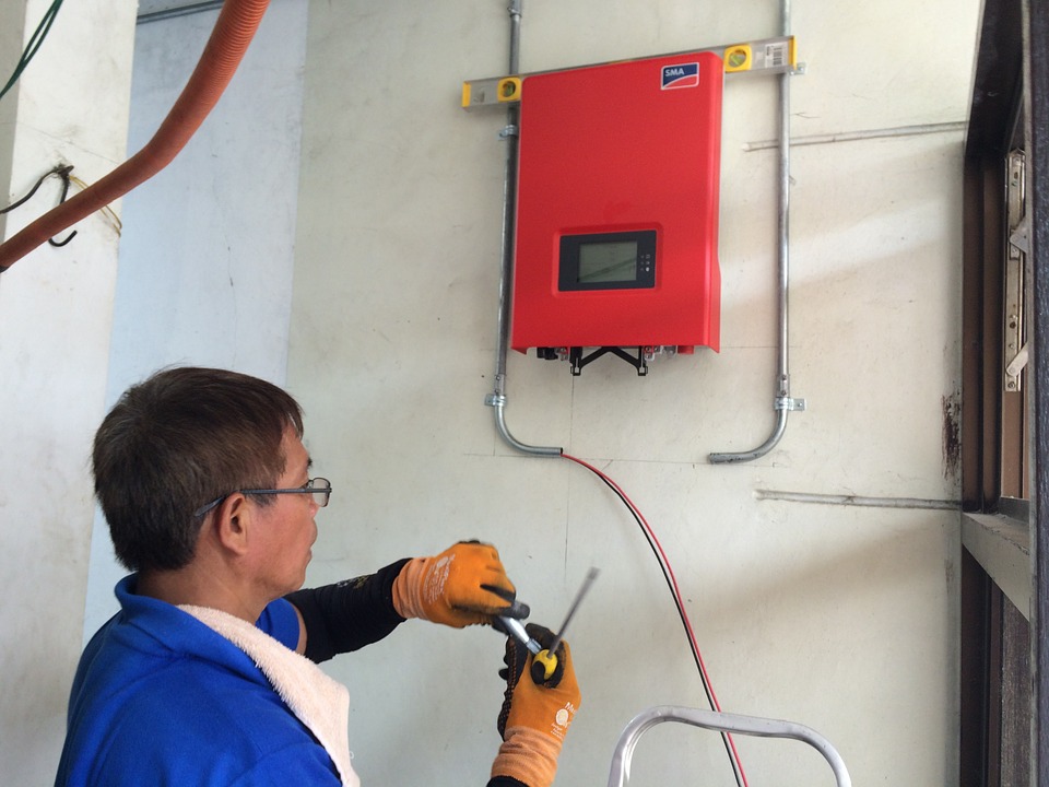 man working on a red electrical box