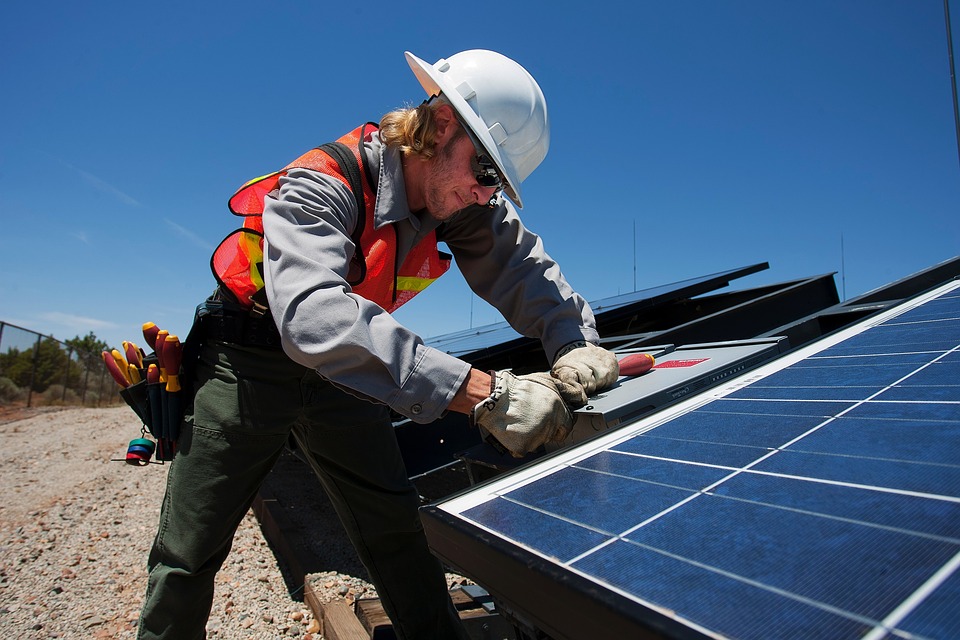 technician working on a solar panel installation on the ground