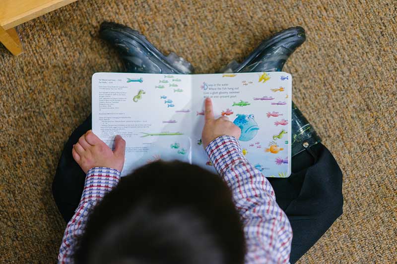 Kid is reading a book