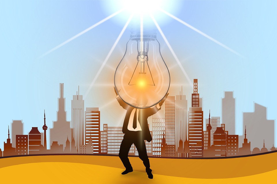 orange and brown illustration of a man holding a giant lightbulb