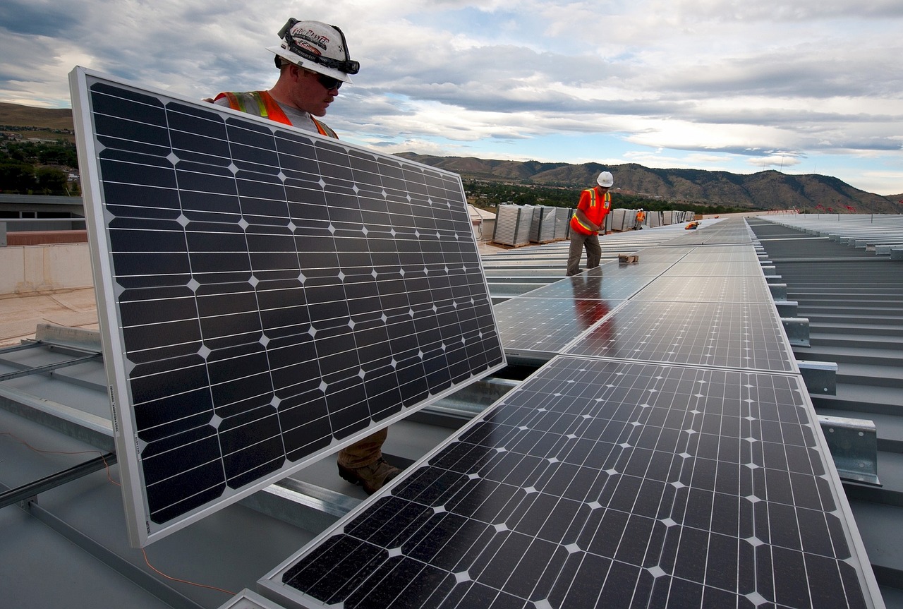 electric workers laying out grid panels