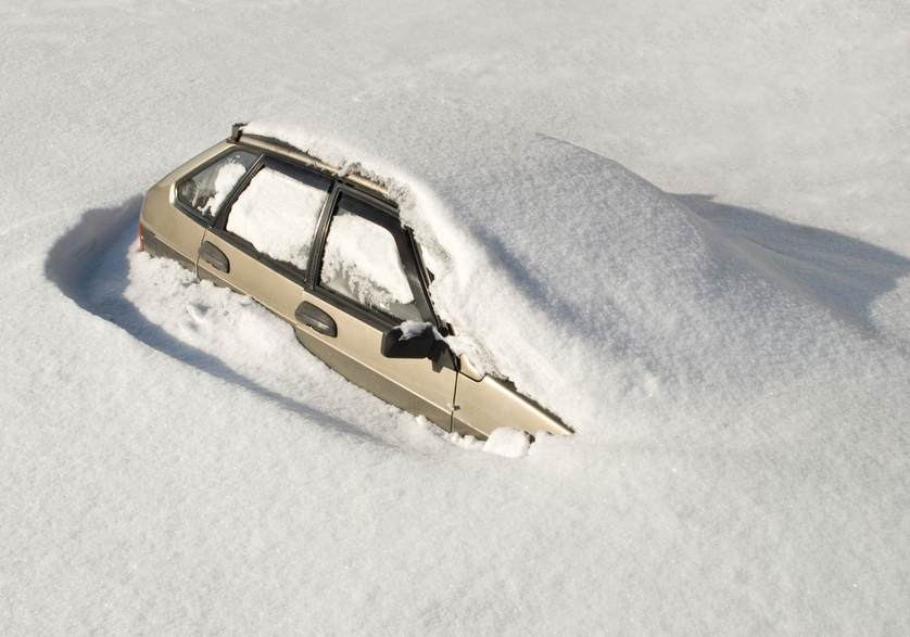 car stuck in snow after a blizzard